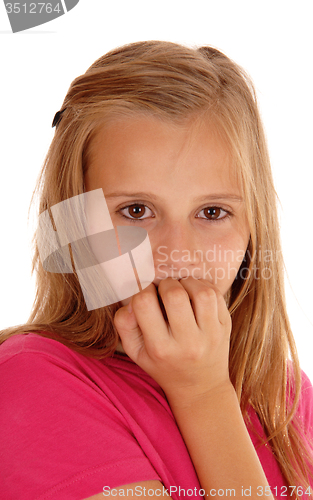 Image of Young girl biting her fingernails.