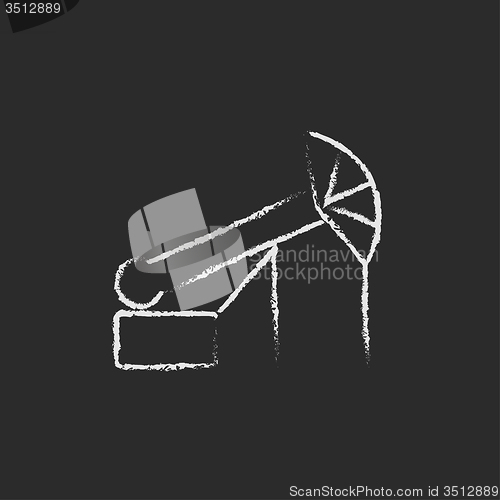 Image of Pump jack oil crane icon drawn in chalk.