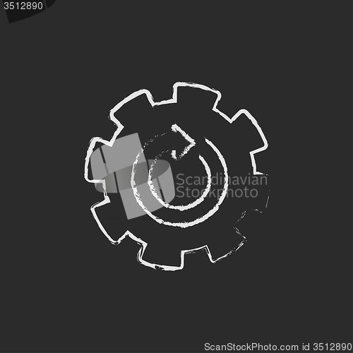 Image of Gear wheel with arrow icon drawn in chalk.