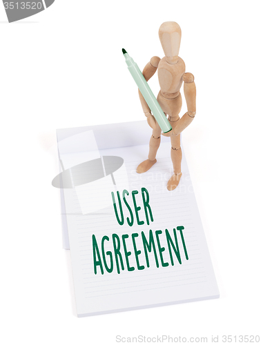 Image of Wooden mannequin writing - User agreement