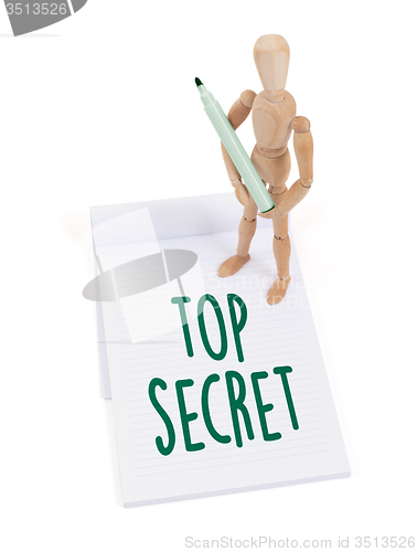 Image of Wooden mannequin writing - Top secret
