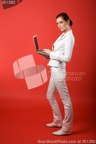 Image of Female with Computer on Red