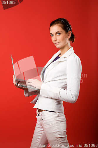 Image of Female with Computer on Red