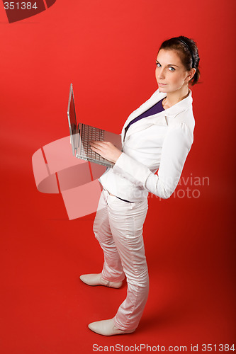 Image of Female with Computer on Red