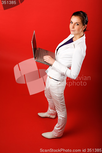 Image of Female with Computer on Red