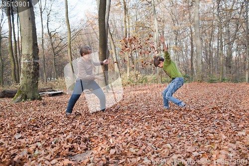 Image of Kids enjoying at forest in autumn