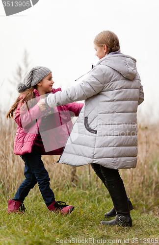 Image of Sisters having fun in colorful autumn day