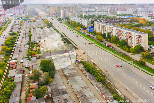 Image of Aerial view on city street, houses and garages