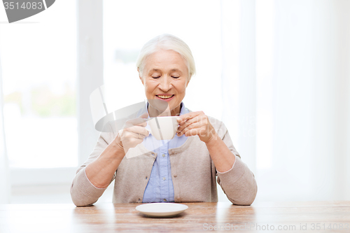 Image of happy senior woman with cup of coffee