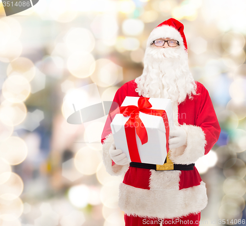 Image of man in costume of santa claus with gift box