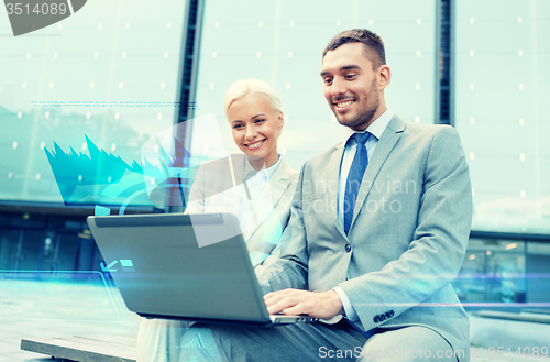 Image of smiling businesspeople with laptop outdoors