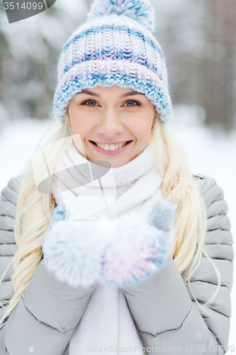 Image of smiling young woman in winter forest