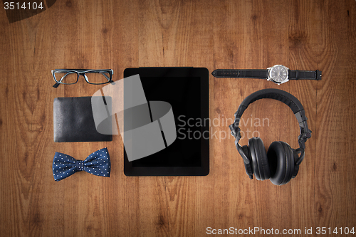 Image of tablet pc, headphones with hipster personal stuff