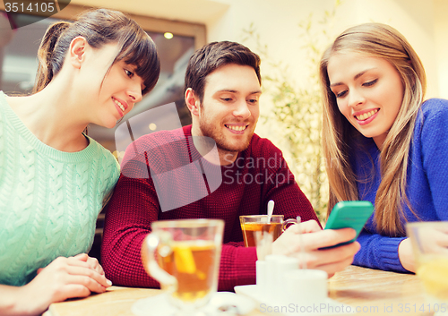 Image of group of friends with smartphone meeting at cafe