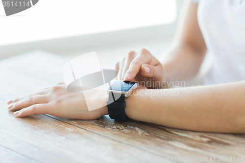 Image of close up of hands setting smart watch