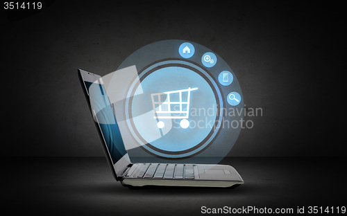 Image of laptop computer with shopping cart icon projection