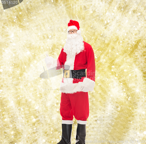 Image of man in costume of santa claus showing thumbs up