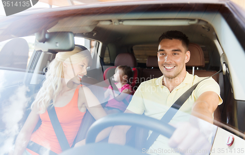 Image of happy family with little child driving in car