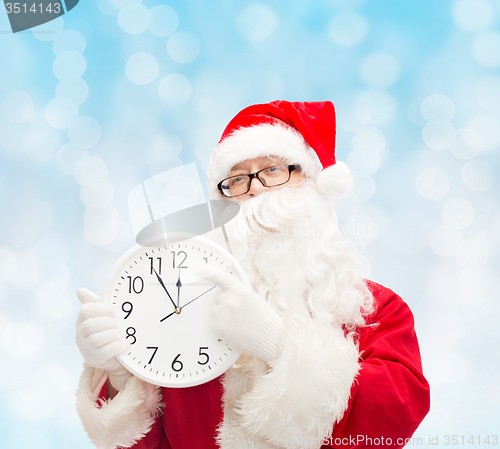 Image of man in costume of santa claus with clock