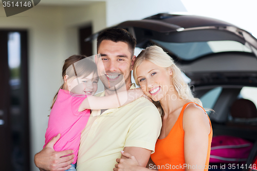 Image of happy family with hatchback car at home parking