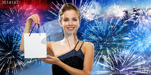Image of smiling woman with white blank shopping bag