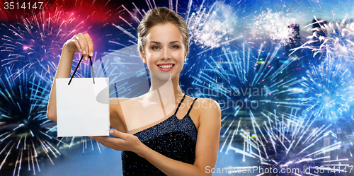 Image of smiling woman with white blank shopping bag