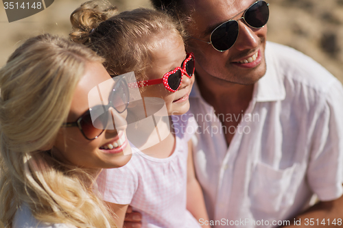 Image of happy family in sunglasses on summer beach