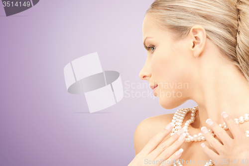 Image of beautiful woman with pearl necklace over violet