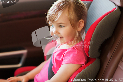 Image of happy little girl sitting in baby car seat