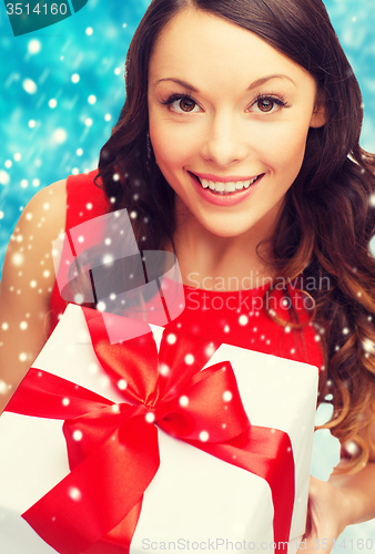 Image of smiling woman in red dress with gift box