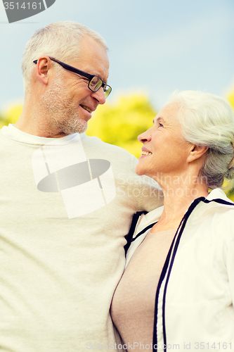 Image of senior couple hugging in city park