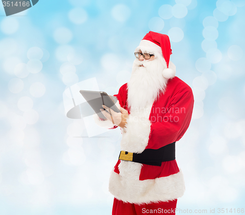 Image of man in costume of santa claus with tablet pc