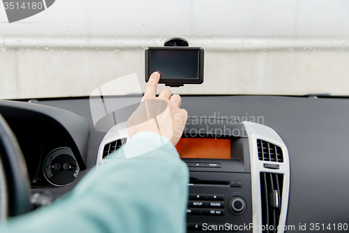 Image of close up of man with gps navigator driving car