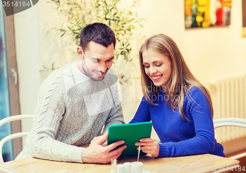 Image of happy couple with tablet pc at cafe