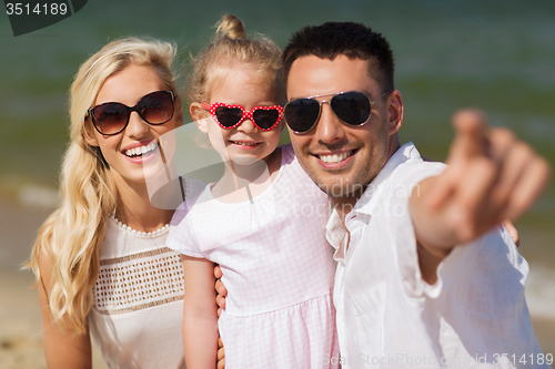 Image of happy family in sunglasses on summer beach