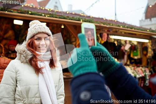 Image of couple taking selfie with smartphone in old town