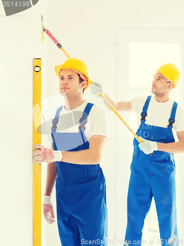 Image of group of builders with tools indoors