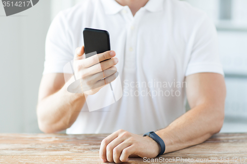 Image of close up of man with smart phone and watch