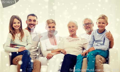 Image of happy family sitting on couch at home