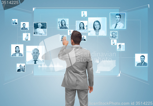 Image of businessman with contacts icons on virtual screen