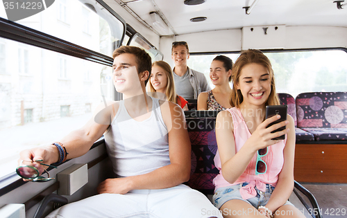 Image of happy teenage friends traveling by bus