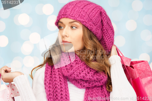 Image of young woman in winter clothes with shopping bags