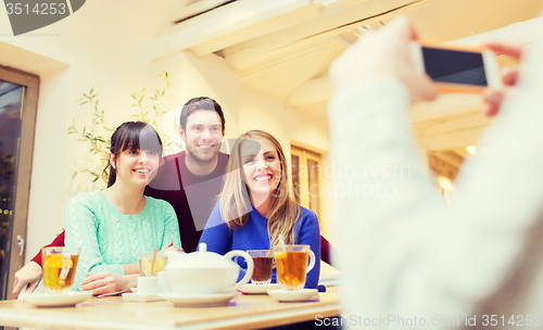 Image of group of friends taking picture with smartphone