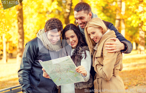 Image of group of friends with map outdoors