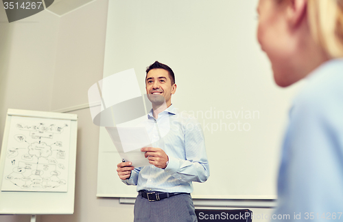 Image of smiling business people meeting in office