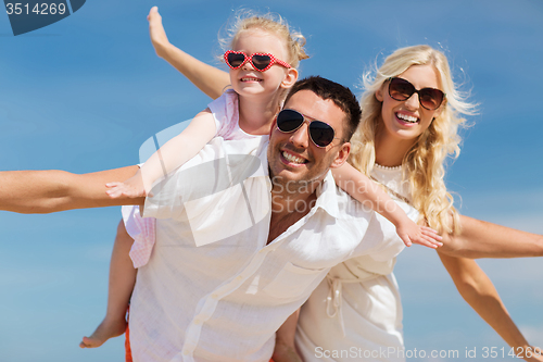 Image of happy family having fun over blue sky background