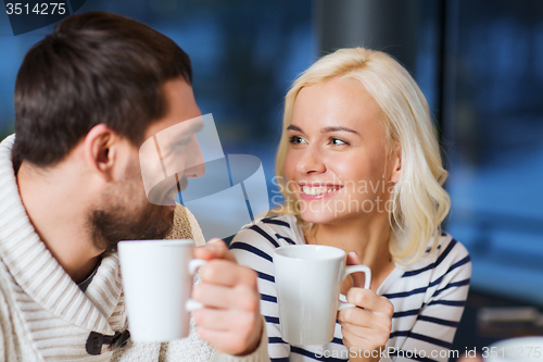 Image of happy couple meeting and drinking tea or coffee