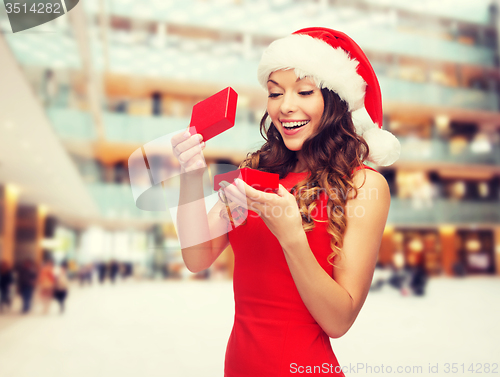 Image of smiling woman in red dress with gift box