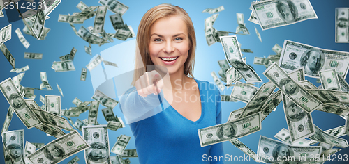Image of smiling woman with money pointing finger on you