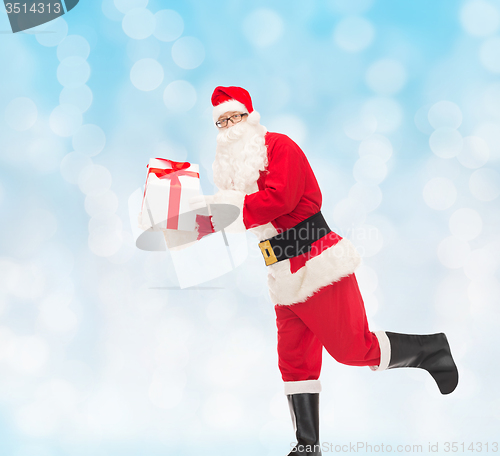 Image of man in costume of santa claus with gift box